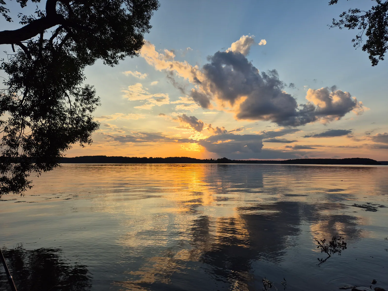 A golden sunset reflected across water in 2024